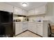 Efficient kitchen space with white cabinets and modern appliances at 3821 1/2 Daisy St # 25, Las Vegas, NV 89119