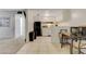 Bright kitchen with white cabinets, black appliances, and a dining area with table and chairs at 3821 1/2 Daisy St # 25, Las Vegas, NV 89119