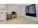 Bright dining area with tile floors, access to kitchen featuring white cabinets at 3821 1/2 Daisy St # 25, Las Vegas, NV 89119