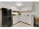 Functional kitchen design with clean white cabinets and black refrigerator at 3821 1/2 Daisy St # 25, Las Vegas, NV 89119