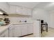 Bright kitchen with white cabinets and appliances offers a cozy cooking space at 3821 1/2 Daisy St # 25, Las Vegas, NV 89119