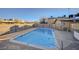 Community pool with a metal fence and clean blue water on a sunny day at 3821 1/2 Daisy St # 25, Las Vegas, NV 89119