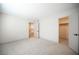 Spacious bedroom with gray carpet, closet, and a view of kitchen at 3823 S Maryland Pkwy # L6, Las Vegas, NV 89119