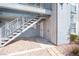 Charming condo featuring a private entrance with decorative metal stairs, shutters, and minimalist landscaping at 3823 S Maryland Pkwy # L6, Las Vegas, NV 89119