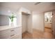 Hallway with white cabinets, light hard surface floors, and view of the bathroom at 3823 S Maryland Pkwy # L6, Las Vegas, NV 89119