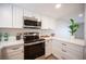 Kitchen with stainless steel appliances, white countertops and cabinets with black hardware at 3823 S Maryland Pkwy # L6, Las Vegas, NV 89119