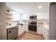 Bright kitchen featuring stainless steel appliances, white cabinets, and light wood floors at 3823 S Maryland Pkwy # L6, Las Vegas, NV 89119