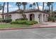 Charming clubhouse exterior with stucco walls, tile roof, and lush landscaping at 4555 E Sahara Ave # 280, Las Vegas, NV 89104