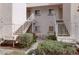 Condo exterior with stairs leading to upper units, surrounded by well-manicured bushes and seasonal decorations at 4555 E Sahara Ave # 280, Las Vegas, NV 89104