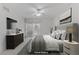 Modern bedroom with a ceiling fan, TV, sliding glass doors, and a stylish gray color scheme at 4555 E Sahara Ave # 280, Las Vegas, NV 89104