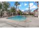 Community pool with clear blue water, concrete sundeck and lounge seating available at 4555 E Sahara Ave # 280, Las Vegas, NV 89104