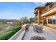 Expansive backyard with covered patio, outdoor kitchen, seating, and panoramic lake and mountain views at 5 Rue De Chateau Pl, Henderson, NV 89011