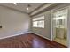 Cozy bedroom featuring hardwood floors, a window, and an ensuite bathroom at 53 Blue Beak Way, Henderson, NV 89012