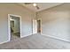 Carpeted bedroom with ceiling fan and three doors leading to other rooms at 53 Blue Beak Way, Henderson, NV 89012