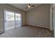 A carpeted bedroom features a ceiling fan and access to a balcony at 53 Blue Beak Way, Henderson, NV 89012