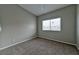 This bedroom features neutral paint, carpet and a window at 53 Blue Beak Way, Henderson, NV 89012