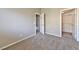 Empty bedroom with neutral carpet and access to walk-in closet and bathroom at 53 Blue Beak Way, Henderson, NV 89012