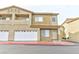 Inviting two-story townhouse featuring attached garage, balcony, and manicured landscaping at 53 Blue Beak Way, Henderson, NV 89012
