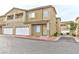 Inviting two-story townhouse featuring attached garage, balcony, and manicured landscaping at 53 Blue Beak Way, Henderson, NV 89012