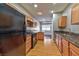 Galley kitchen with wood cabinets, granite countertops, and black appliances at 53 Blue Beak Way, Henderson, NV 89012