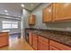 Kitchen with wooden cabinets, granite countertops, and stainless steel dishwasher at 53 Blue Beak Way, Henderson, NV 89012