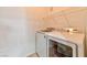 Bright laundry room featuring a newer washer, dryer, and wire shelving at 53 Blue Beak Way, Henderson, NV 89012