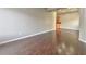 Spacious living room with dark hardwood floors, neutral walls, and kitchen access at 53 Blue Beak Way, Henderson, NV 89012