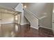 Open floor plan with dark hardwood floors, staircase, and bright, natural light at 53 Blue Beak Way, Henderson, NV 89012