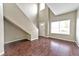 Bright living room featuring soaring ceilings, hardwood floors, and large windows at 53 Blue Beak Way, Henderson, NV 89012