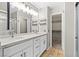 Bathroom with dual sinks, stone countertops, and modern fixtures at 5382 Runningbrook Rd, Las Vegas, NV 89120