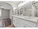Modern bathroom features double sink vanity, stone countertop, and updated lighting at 5382 Runningbrook Rd, Las Vegas, NV 89120