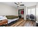 Bedroom features wood-look flooring, ceiling fan, and closet at 5382 Runningbrook Rd, Las Vegas, NV 89120