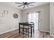Cozy dining area features a dark wood table set, modern floors, and natural light from a window at 5382 Runningbrook Rd, Las Vegas, NV 89120