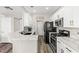 Bright, updated kitchen with white cabinets, stainless appliances, and breakfast bar at 5382 Runningbrook Rd, Las Vegas, NV 89120