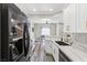 Updated kitchen with black stainless appliances, marble counters, and modern fixtures at 5382 Runningbrook Rd, Las Vegas, NV 89120