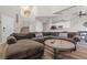 Inviting living room boasts a sectional sofa, hard surface floors, and a staircase to the upper level at 5382 Runningbrook Rd, Las Vegas, NV 89120