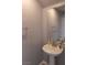 Half bathroom features a pedestal sink, mirror, and neutral paint at 5461 Dungaree St, Las Vegas, NV 89118