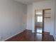 Bedroom with closet with mirrored doors and wood flooring at 5461 Dungaree St, Las Vegas, NV 89118