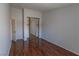 Bedroom with glossy wood floors, and closet with mirror doors at 5461 Dungaree St, Las Vegas, NV 89118