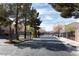 Gated community entrance with well-maintained landscaping, mature trees, and secure access for residents at 5461 Dungaree St, Las Vegas, NV 89118