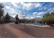 Scenic view of the community pool surrounded by a fence and lush landscaping at 5461 Dungaree St, Las Vegas, NV 89118