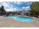 Community pool area featuring crystal-clear water, shaded picnic tables, and well maintained landscaping at 5461 Dungaree St, Las Vegas, NV 89118