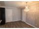 Open dining area features a decorative chandelier, wood-look floors, and neutral walls at 5461 Dungaree St, Las Vegas, NV 89118