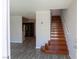 Entryway with hardwood stairs, gray flooring, and an open view to the kitchen with stainless appliances at 5461 Dungaree St, Las Vegas, NV 89118