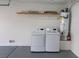 Garage with laundry machines, utility shelf, painted floors, and modern water heater at 5461 Dungaree St, Las Vegas, NV 89118