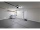 Spacious garage with laundry machines, painted floor, overhead lighting, and storage at 5461 Dungaree St, Las Vegas, NV 89118