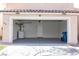 Garage with laundry machines, painted floors, overhead lighting, access door, and trash cans at 5461 Dungaree St, Las Vegas, NV 89118