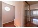 Upstairs hallway features wood floors, decorative window, and closet with sliding mirror doors at 5461 Dungaree St, Las Vegas, NV 89118