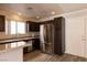 Kitchen features stainless steel appliances, dark cabinets, light countertops, and wood-look flooring at 5461 Dungaree St, Las Vegas, NV 89118