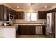 Well-appointed kitchen with stainless steel appliances, dark cabinetry, and plenty of counter space for cooking at 5461 Dungaree St, Las Vegas, NV 89118